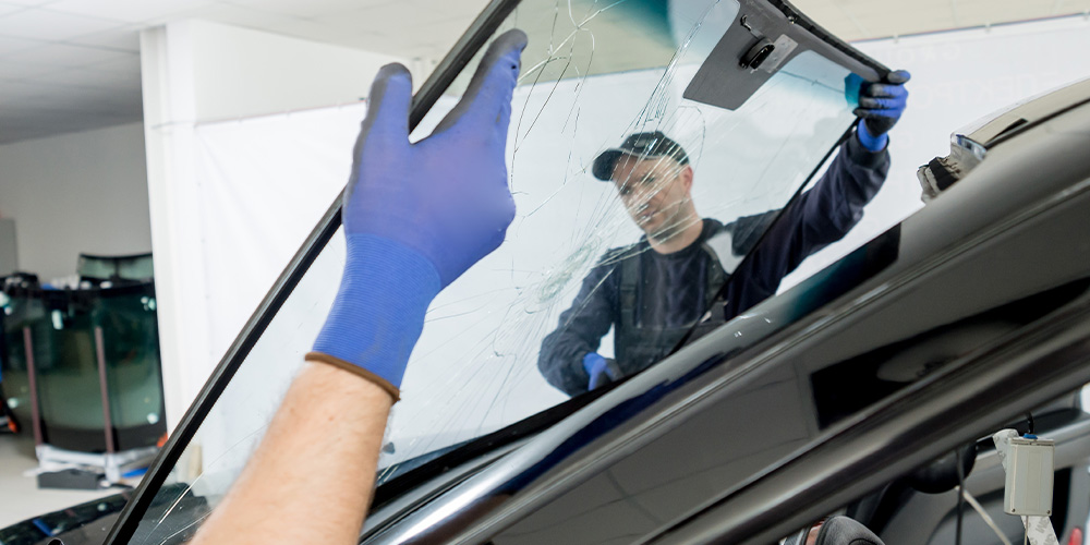 Image Of Employees Removing A Broken Windshied from the car